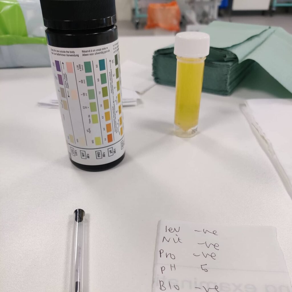 A tube with urine, a paper and pen.